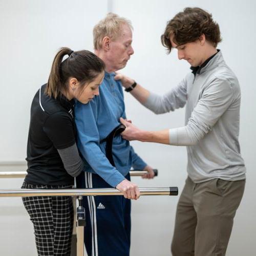 Physical therapy students work with community members during a Community Clinic in the