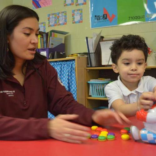 AmeriCorps member working with a young student